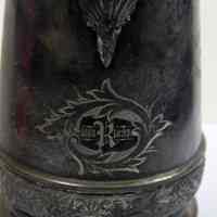          detail of engraved dates under spout
   