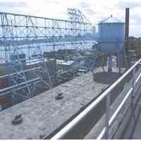 Color photo of back of Maxwell House Coffee sign support structure, building no. 2 with water tank tower, Hoboken, n.d. 2000.