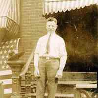 Digital image of sepia-tone photo of John Muller standing on steps outside 107 Bloomfield St., Hoboken, 1920.