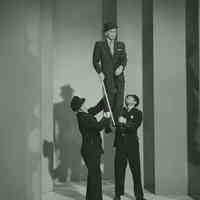 Black-and-white photo, movie still, of Frank Sinatra in "Police Pickup" dance dream sequence from film "Pal Joey", no place, [1957].