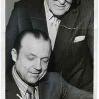 B+W photo of 2 men that served as Hoboken City Clerk, Anthony J. Amoroso (standing) & Arthur C. Malone, Hoboken, Apr. 9, 1971.