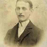 Sepia-tone photo of a young man posed in photographer