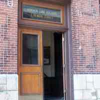          12: north facade, main entrance door with name and address
   