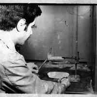 B+W photo of flammability test of of plastics at United States Testing Co., Hoboken. N.d., ca. 1970-1980.