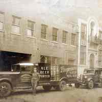 Sepia-tone photo of Husex Beverage Co., 510-512 4th St. with delivery trucks, Hoboken, n.d., ca. 1933-1940.