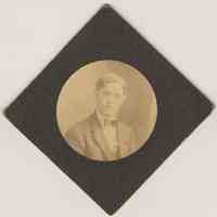 Sepia-tone photo of an unidentified young man posed in studio, Jersey City, no date, ca. 1900-1915.