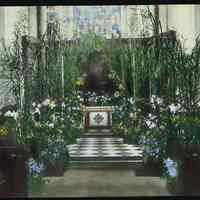 Lantern slide, color, of a church interior with floral decorations, used for promotional display in Hoboken, no date, ca. 1920.