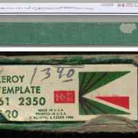          template with box; detail of printed label on end of box tray
   