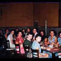 Color slide of a group of women around a table.