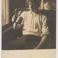 Postcard: [Young boy (probably George Kirchgessner) seated in chair holding a lidded stein.] Probably Hoboken. No date, circa 1920