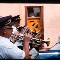 Color slide of men playing trumpets in a parade.