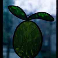 Color slide of a stained glass pear in a window.