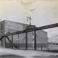 Sepia tone photo of the North German Lloyd S.S. Co. entry gates, Bremen Pier, River St. near Third St., Hoboken, n.d., ca. 1890s.