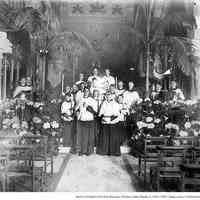 Digital image of photo of the chapel interior of Church of the Holy Innocentswith Father Magill and altar boys, Hoboken, ca. 1890