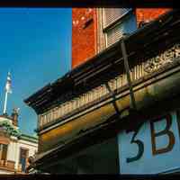          Color slide of detail view of cornice on the NE corner of Newark & Washington with Hoboken City Hall pediment and flagpole in the background picture number 1
   