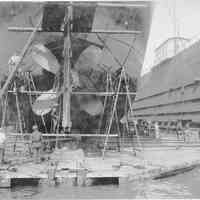 B+W photo of steerage repair to an unknown ship in a dry dock south of the Lackawanna Ferry Terminal, Hoboken, no date, ca. 1922-1930.