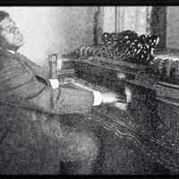          slide 11: image of printed photo of mature Wiggins at piano
   