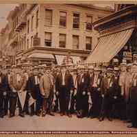 Sepia-tone photo of southeast corner of Newark & Washington Sts. looking north with Hoboken Delegation to National Convention, Hoboken, June 1912.