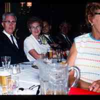 Color slide of a group of people at a table.