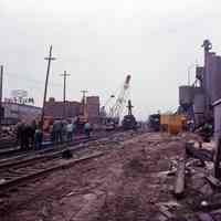 Color photos, 3, of repair crews working on tracks after a train wreck on westside tracks, Hoboken, May 1972.