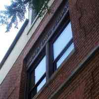          21: west facade, second floor windows with lettering above
   