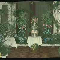 Lantern slide, color, floral decorated lobby or reception room, used for promotional display in Hoboken, no date, ca. 1920.