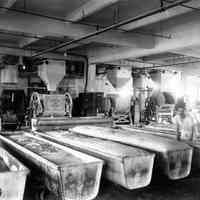 Sepia-tone photo of the mixing room with troughs of fermenting bread at John Schmalz