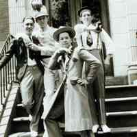 B+W photo of four Our Lady of Grace Drum Corps members outside the OLG Orphanage, ca. 1936-1938.