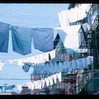 Color slide of laundry hanging between buildings.