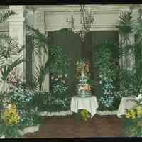 Lantern slide, color, floral decorated lobby or reception room, used for promotional display in Hoboken, no date, ca. 1920.