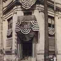 Sepia-tone photo of the Hoboken Trust Company bank building, 14th & Washington Sts., with bunting, Hoboken, n.d, ca.1900.