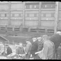 Color slide of actors and crew on pier set of the motion picture "On the Waterfront", Hoboken, no date, ca. late 1953-early 1954.