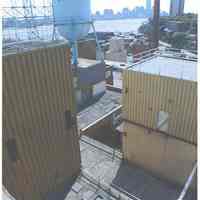 Color photo of the back of Maxwell House Coffee sign support structure, building no. 2 with water tank tower, Hoboken, n.d, ca. 2000.