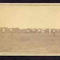 Digital image of a carte de visite featuring a sepia-tone photo of a staged baseball game. On the reverse is written “A Game of Base Ball Hoboken N.J.” C. 1864-1866.