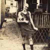 Digital image of photo of woman in bathing suit with doll near porch, no place (probably not Hoboken), no date, circa late 1910-1920.