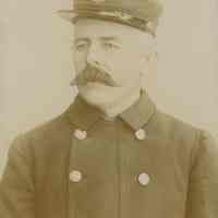 Sepia-tone photo of an unidentified fireman, probably James Miller, posing in his uniform, New York, no date, ca. 1880.