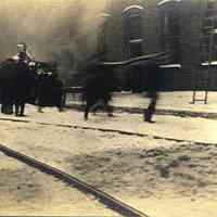 Sepia-tone photo of exterior view of a fire at John Schmalz