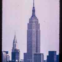 Color slide of close-up view from River & 3rd looking E at the Empire State Building and the Chrysler Building on the left