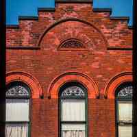 Color slide of close-up view of brick pediment, semicircular arches and stained glass window heads at 814 Hudson between 8th and 9th