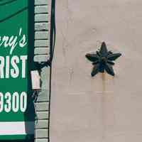 Color photo of the south end of the awning sign for Mary