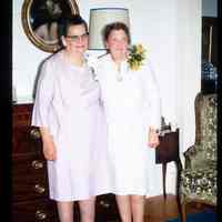 Color slide of two women standing in a room.