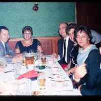 Color slide of a group of people at a table.