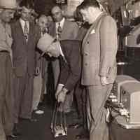 Digital image of b+w photo of Mayor Fred DeSapio et al being given a demonstration of magnetic block by a Sheriff, Hoboken, no date, ca. 1947-1951.