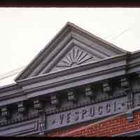          Color slide of close-up view of pediment, cornice, brackets and frieze reading 