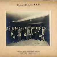 Sepia-tone group photo: Hudson & Manhattan R.R. Co. Arrival at Church Street Terminal, New York, of the Directors and Officers on the FIRST TRAIN FROM HOBOKEN at 4:00 P.M., June 28, 1909.