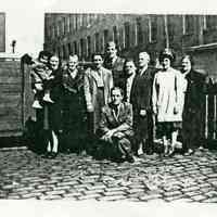 Black-and-white photocopy of a group photo of 9 adults and one child in the backyard of 721 Adams St., Hoboken, ca. 1942.