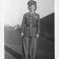 Digital image of B+W photo of Bea Theresa posed outdoors in an army uniform belonging to her husband, no place, December 1943.