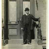 Sepia-tone photo of Karl Beck on front stoop of 600 Madison Street, Hoboken, 1914.