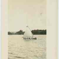          B+W photo with postcard back of a canoe with sail on a lake, no location known, no date, ca. 1940. picture number 1
   