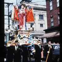 Color slide of Madonna statue being carried down a street.